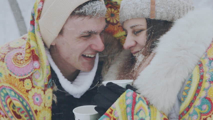 young couple in love in the snow-covered forest