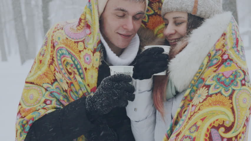 young couple in love in the snow-covered forest