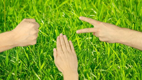 Rock paper scissors hand game. Three hands top view. Green grass background outdoor. Man hand gestures competition. Make choice. Random selection methods. Winner loser tournament. Playful game.