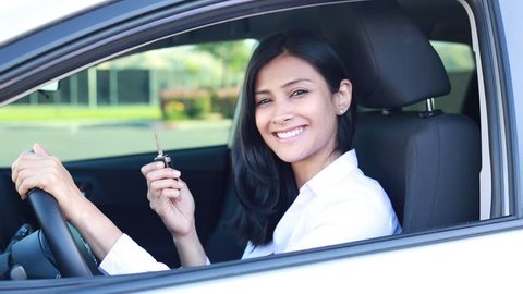 Closeup portrait, young cheerful, joyful, smiling, gorgeous woman holding up keys to her first new car. Customer satisfaction