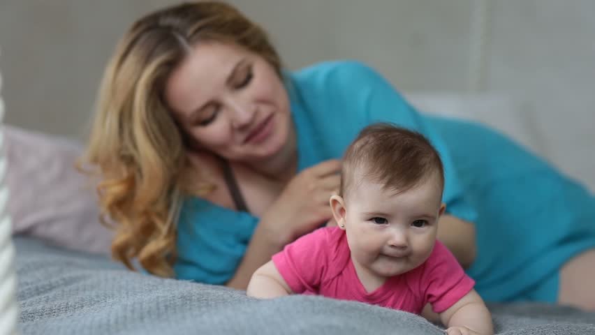 Adorable infant baby crawling on bed