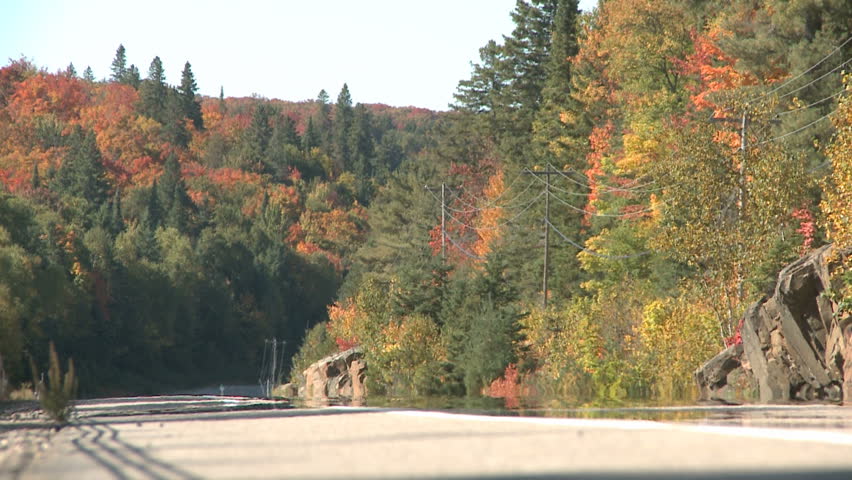 ALGONQUIN PARK, CANADA, SEP 24: A car passing by on a highway with fall colors