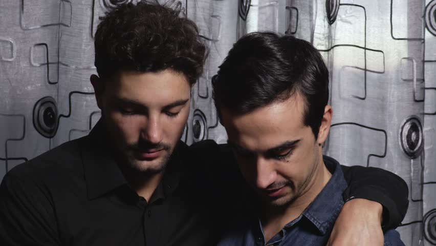 close up on Embraced Gay couple smiling and kissing