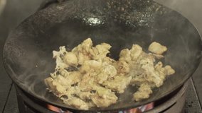 Cooking Thai Food: How to educational video on asian cuisine with chicken, vegetables, egg fried noodles in hot Wok over fire