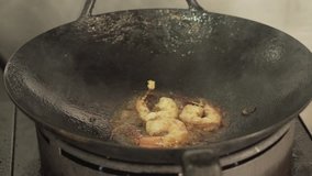 Cooking Thai Food: How to educational video on Asian cuisine shrimp in hot Wok over fire at restaurant