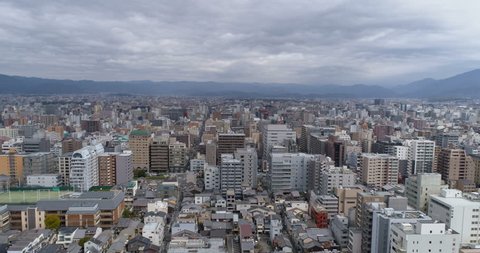 Aerial shot above Kyoto buildings with skyline view, Japan