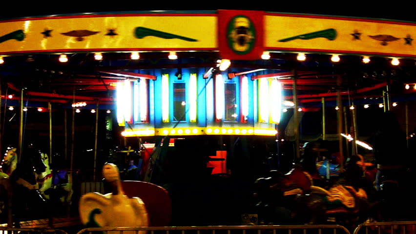 An empty carousel at night evokes a surreal carnival atmosphere perfect for
