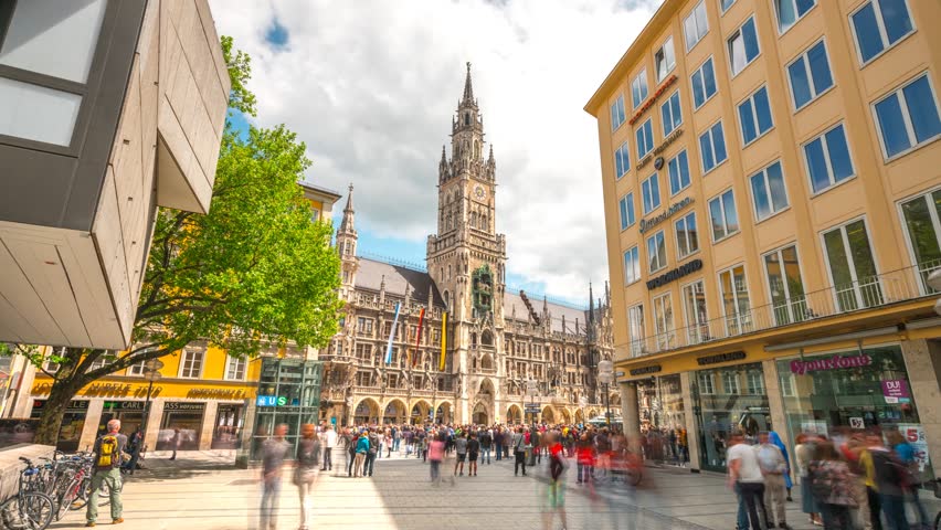 Munich, Germany - May 22, 2017: Moving Hyperlapse video in front of City Hall at Marienplatz square in 4K, Munich Bayern, Germany. Mary's public square Munich and New town hall in sunny day Royalty-Free Stock Footage #27020008