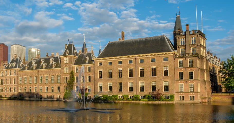 Timelapse of the Binnenhof House of Parliament and the Hofvijver lake with downtown skyscrapers in background. The Hague, Netherlands. Zoom out effect