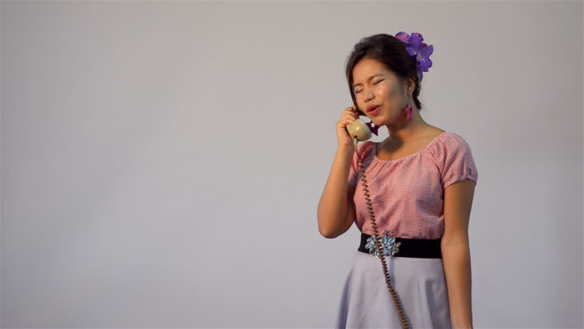 Asian woman in vintage style fashion, having an angry conversation on the phone