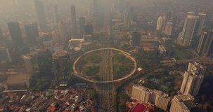 Video footage of aerial view of highway intersection with skyscrapers in Jakarta, Indonesia. Shot in 4k resolution