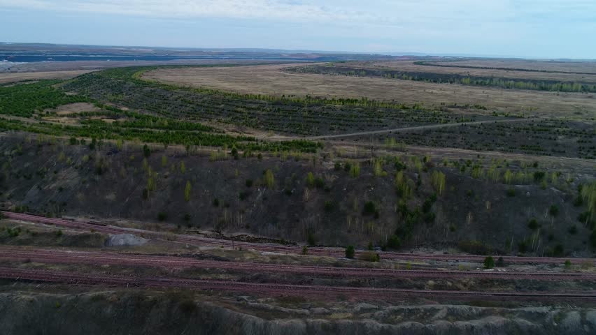Big pit on production in the open way of minerals from the earth, flight over the field, shooting from air
