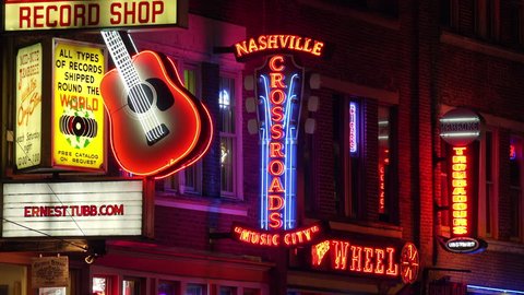 NASHVILLE, TENNESSEE - JULY 7th: Neon signs at night along Broadway Street in Nashville, Tennessee on July 7th, 2016.
