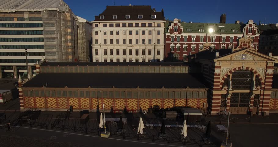 Aerial view drone footage of Helsinki old market building area and boats near sea terminal and harbour with city skyline and Baltic Sea view in the capital of Finland, northern Europe