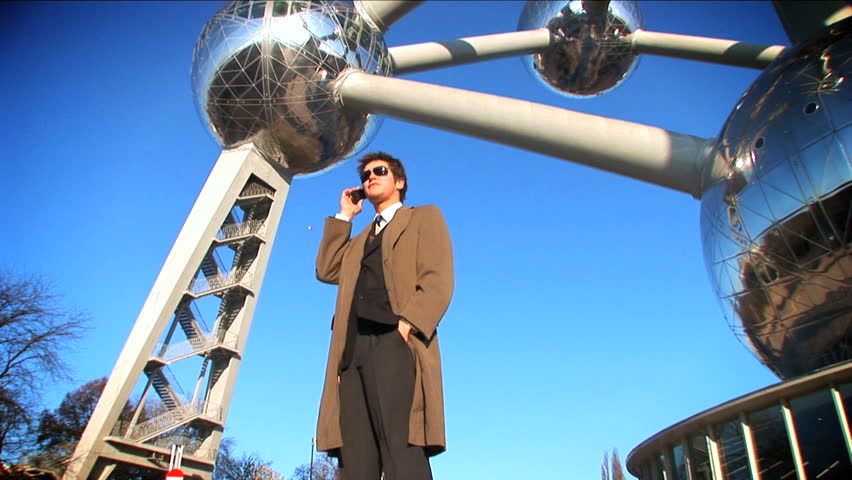 Young businessman using  mobile phone outdoors
