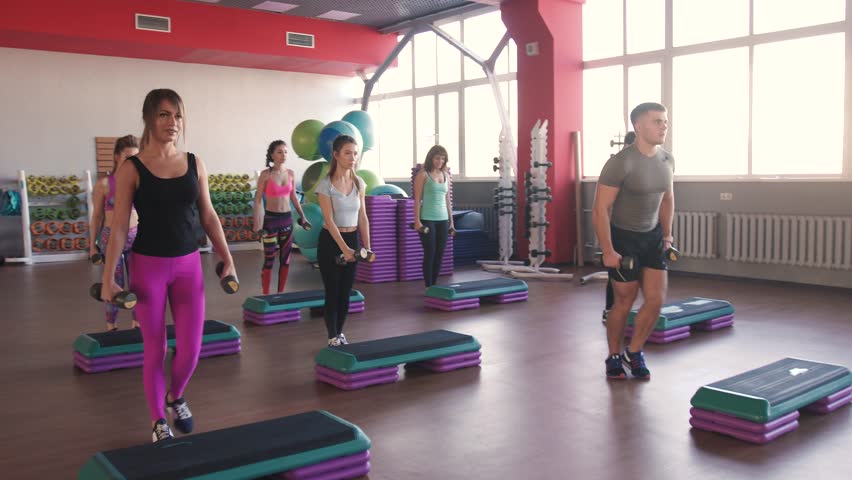 Aerobics class stepping and clapping together at the gym Royalty-Free Stock Footage #27045985