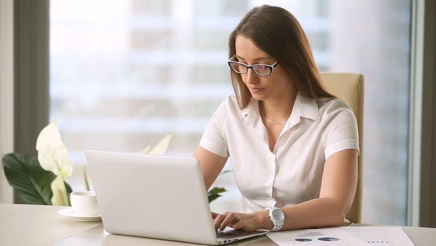 Young businesswoman taking off glasses while working on laptop at office, feeling discomfort and eye strain after long wearing, massaging nose bridge, blurry irritated dry eyes, eyesight problems  Royalty-Free Stock Footage #27047887