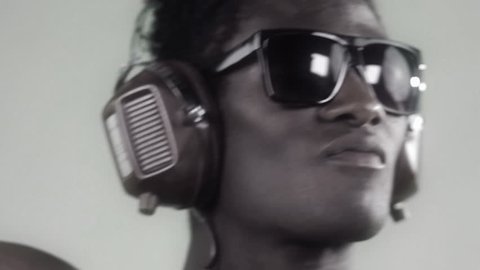 african cool guy dancing with headphones and glasses with a silver style Stock Video