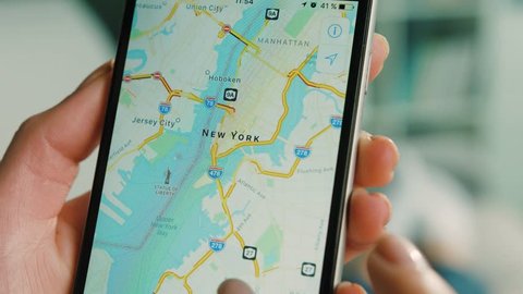 New York - March 10, 2017: Woman using google map app to finding the interesting place for future trip. Gps. Close up.