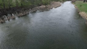 Aerial shot. Footage of a drone that is flying over the river.