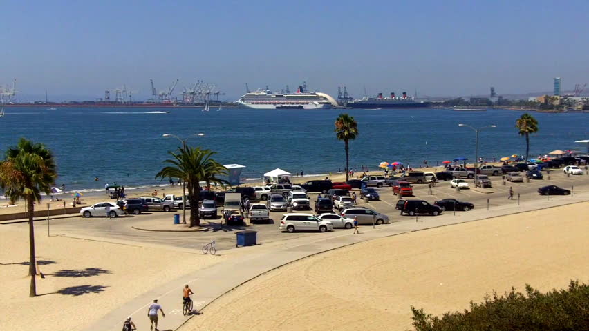 A crowded beach parking lot, beach and harbor on a hot summer day in Long Beach,