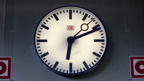 FRANKFURT, GERMANY - MAY 10, 2017: Timelapse shot of an analog Deutsche Bahn clock with the DB logo on it in the Frankfurt Airport train station.