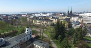 Aerial view drone footage of Helsinki old church, bay area with boats and road traffic near sea terminal and harbour with city skyline and Baltic Sea view in the capital of Finland, northern Europe