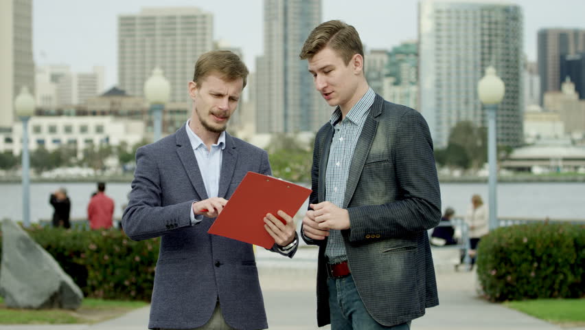 Business discussion on a sidewalk in Coronado, San Diego