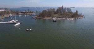 Aerial view drone footage of Helsinki bay area made on 19 May 2017, boats and villas on islands near sea terminal and harbour with city skyline, Baltic Sea view in capital of Finland, northern Europe