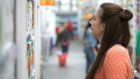 Footage woman buys juice in supermarket. 4k video