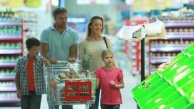 Family stopping by a vegetable section to take fresh cabbage - Powered by Shutterstock - Get 15% off with code: PIKWIZARD15