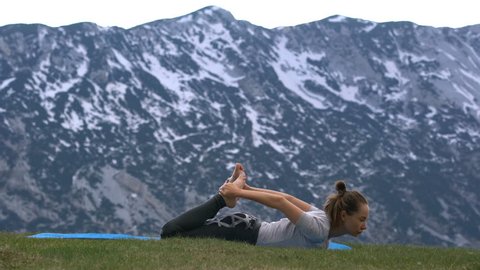 woman practicing yoga outdoors