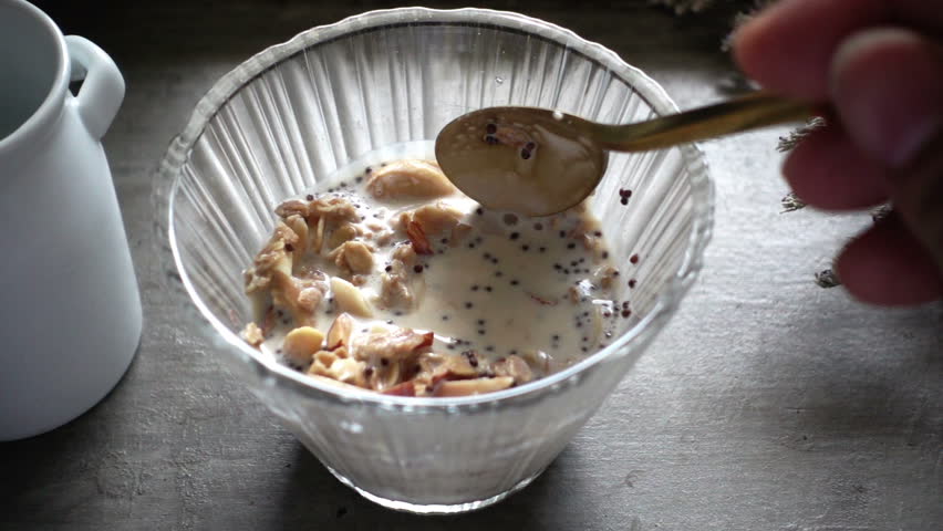 Granola Cereal, Nuts and Raisins on spoon, HD slow motion  | Shutterstock HD Video #27083326