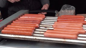 Street food. Cooks grilled sausages. Full HD 1920x1080 Video Clip