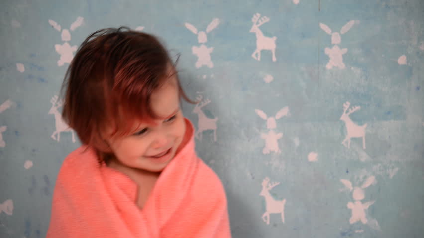 The child is wrapped in a towel.