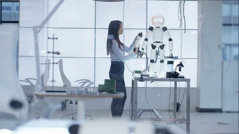 4K Technical engineer working on construction of automated robot in modern lab