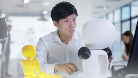 4K Asian electronics engineer working in lab with robot prototype Stockvideo