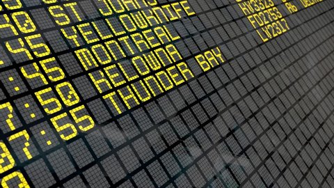 Close-up of an airport departure board to Canadian cities destinations, with environment reflection. Part of a series. 4k video resolution (4096x2304).
