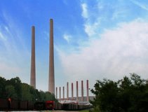 Wide shot of a steam power plant with big smoke stacks DV NTSC video
