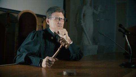 judge with a hammer in his hand in the court room
