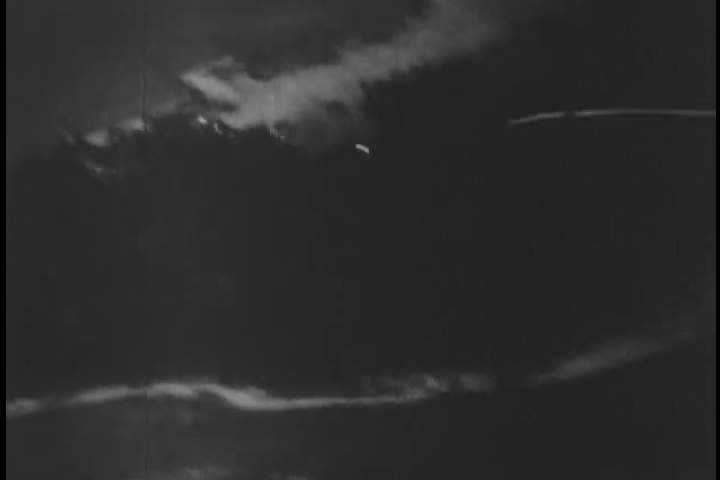 1940s: Aerial combat footage shows bullets fired at the shores of the Marshall islands in 1944. An enemy plane is also shot at.