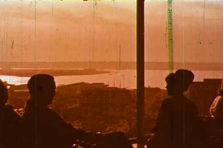 1960s: A server serves a couple in a restaurant overlooking the coastline and waves and beaches are shown, in La Jolla, California, in 1966.