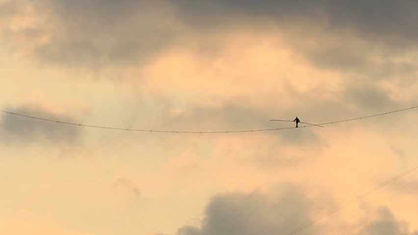 Tightrope Walker Sky Timelapse. Someone walking a tightrope high in the sky.