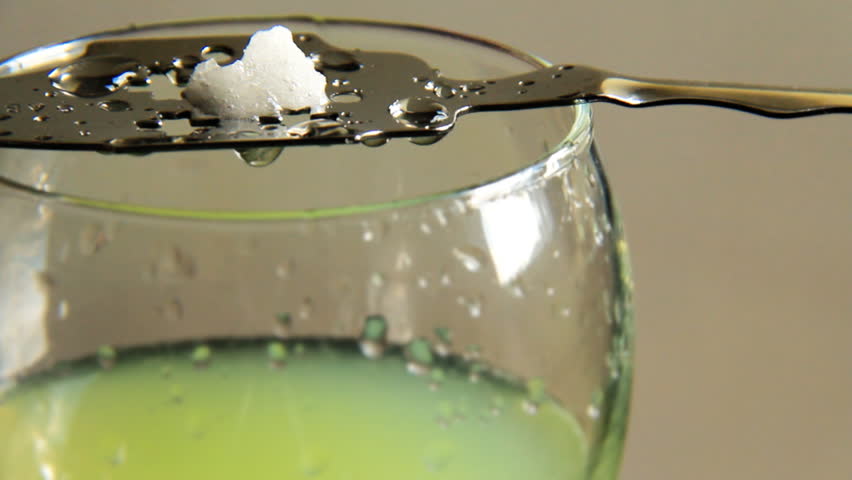 Absinthe 3. Dripping cold water through a sugar cube on top of a slotted