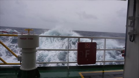 Bad weather in the ocean with high waves during sailing with offshore marine vessel.