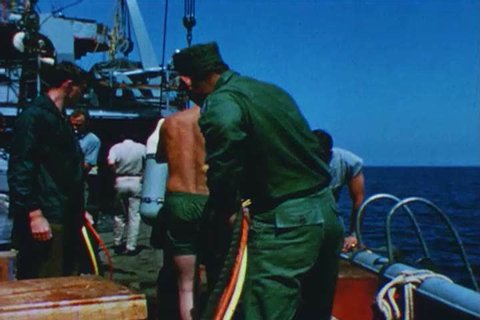 1960s: United States Navy divers test a variable buoyancy lift system and explosive stud driver, underwater, off Anacapa Island, in California, in 1969.