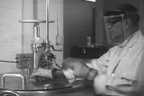 1960s: Dr. James Grace explains the study of leukemic cell cultures in newborn monkeys at the National Cancer Institute laboratories in Maryland, in 1966.