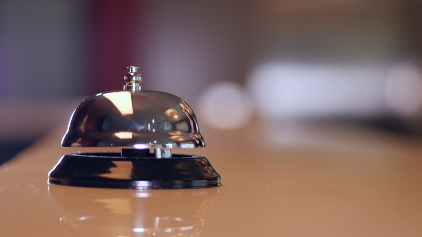 Hotel visitor ringing vintage bell at the Reception. Royalty-Free Stock Footage #27117055