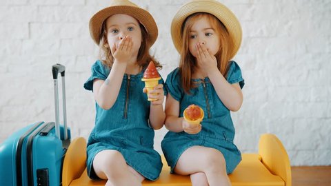 Two little girls send kisses and wait for summer vacation