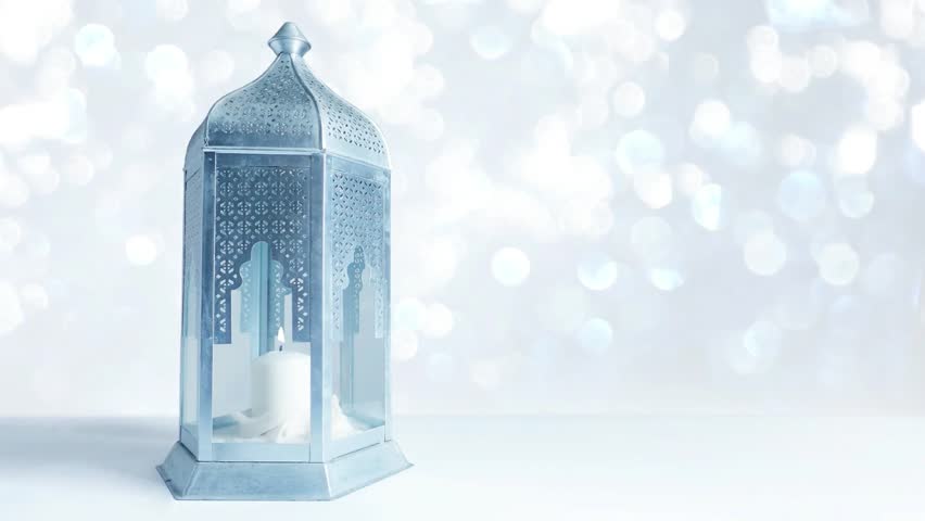 Arabic ornamental lantern with burning candle and glittering silver and blue background with bokeh lights. Loopable Ramadan HD footage. Royalty-Free Stock Footage #27118489